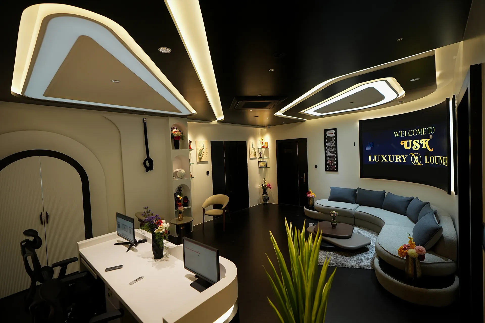USK Luxury AV Lounge reception desk with curved lounge seating and welcome screen
